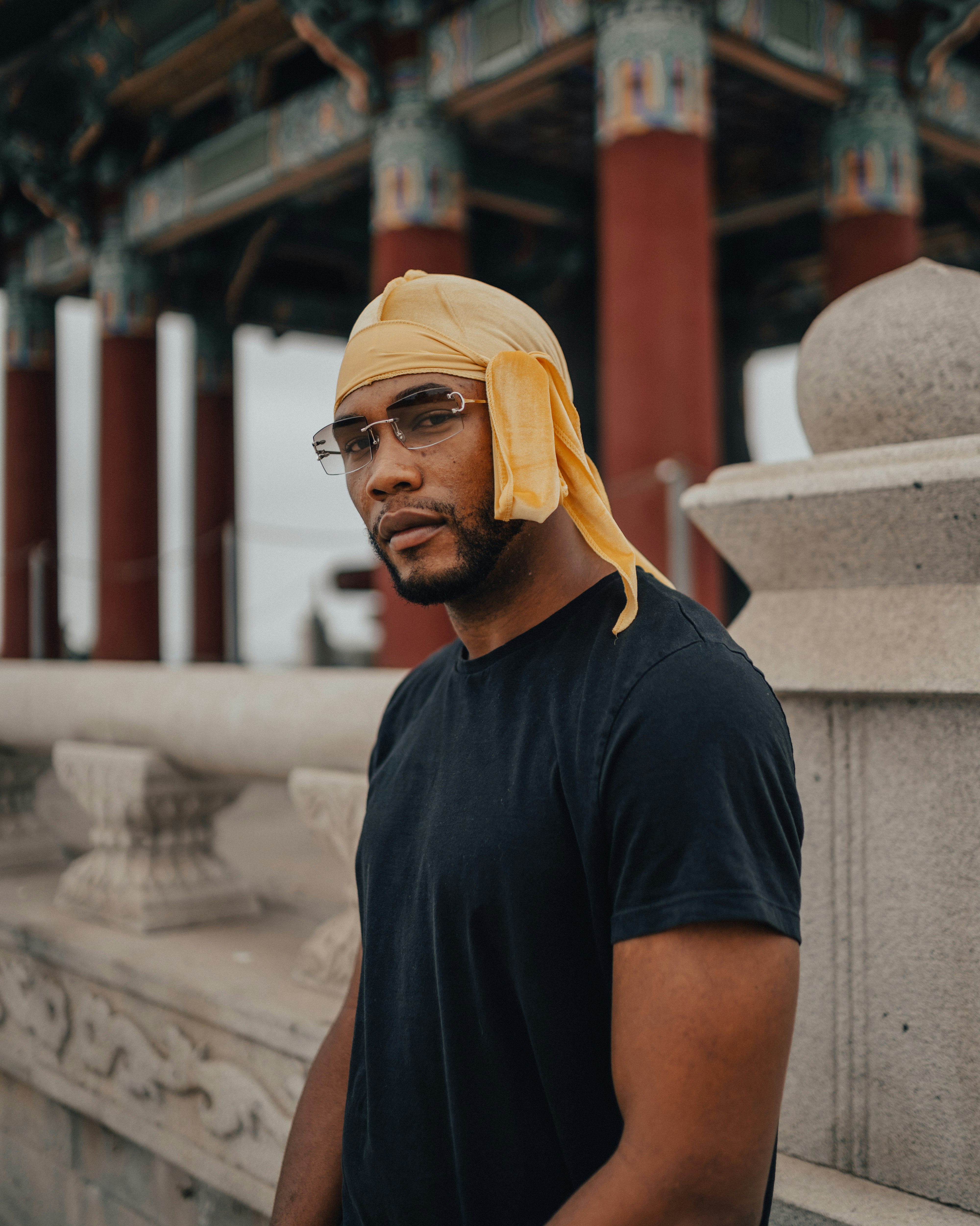 man in black crew neck t-shirt wearing yellow bandana